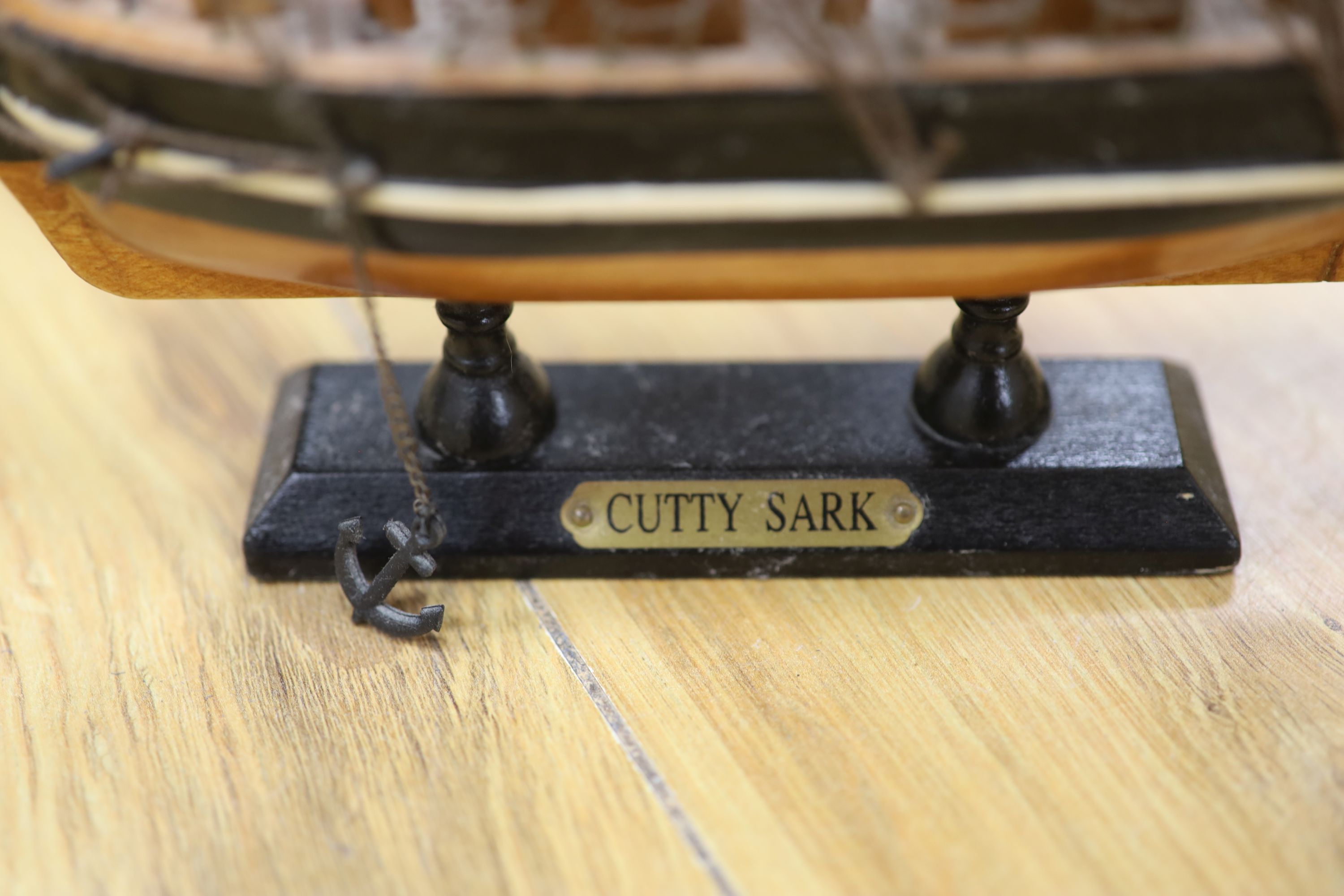 Three model ships: The Cutty Sark, The USS Constitution and Fragata, together with a carved wood Marlin